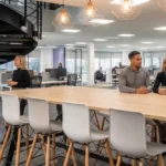 Team members in an office space having conversations.